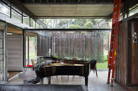 Contemporary room with grand piano and glass walls.