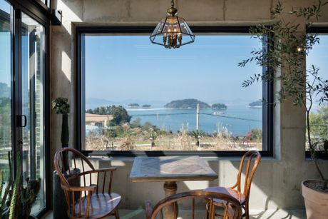 Cozy dining corner with sea view through large window.