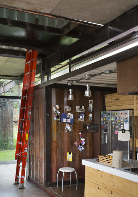 Industrial-style kitchen with wooden accents and a red ladder.