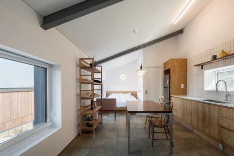 Modern minimalist kitchen and dining area with natural light.