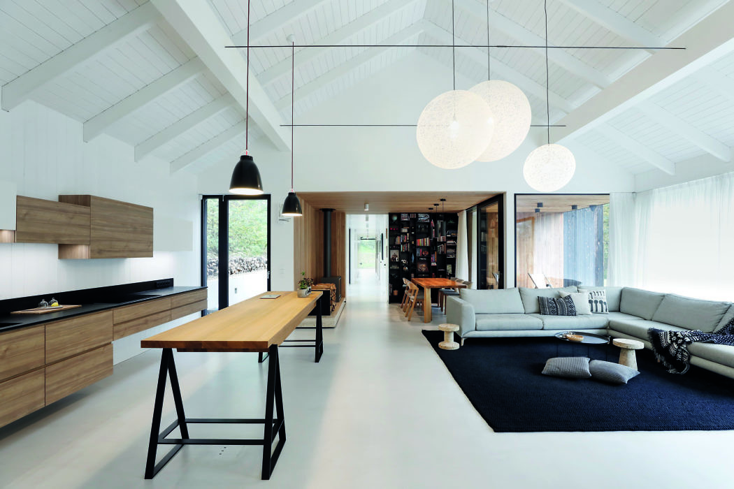 Contemporary open-plan living space with high ceilings and minimalist decor.
