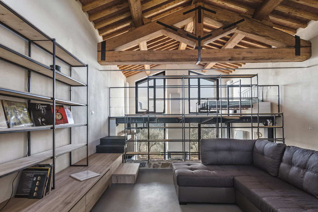 Contemporary loft space with exposed beams and industrial staircase.