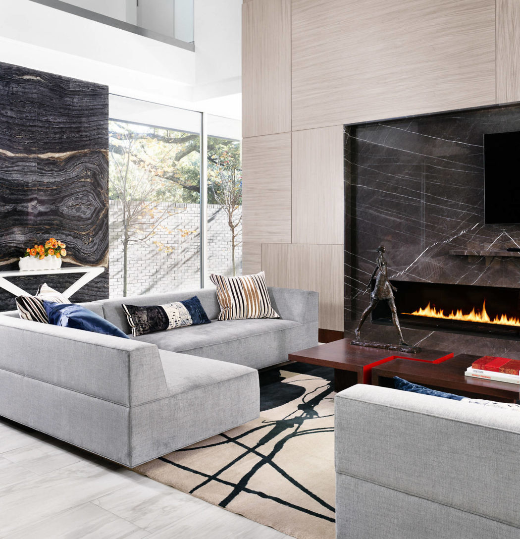 Modern living room with a fireplace, sofa, and large window.