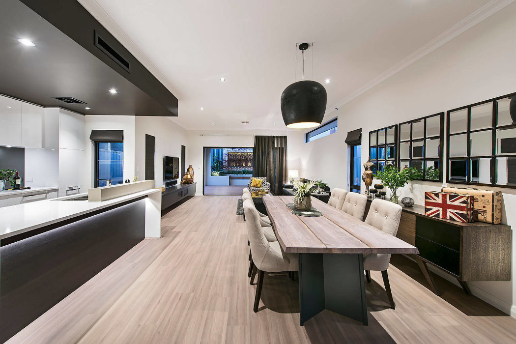 Modern kitchen and dining area with large table, pendant lighting, and open layout.