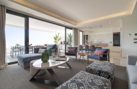 Contemporary living room with open floor plan and ocean view.