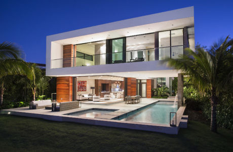 Contemporary home with pool at twilight.