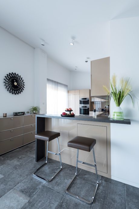 Modern kitchen interior with breakfast bar and stools.