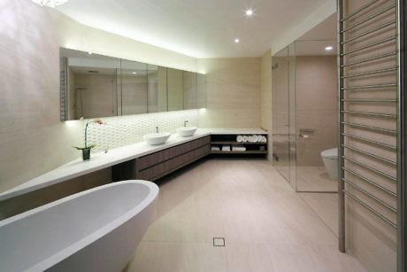 Modern bathroom with tub, shower, and double vanity.