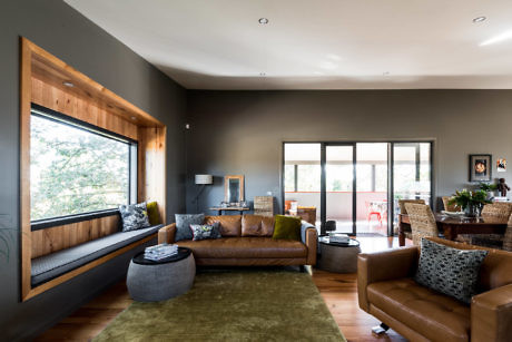 Contemporary living room with large window seat and neutral tones.