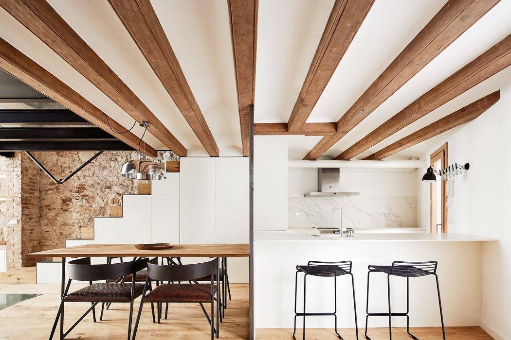 Contemporary kitchen with exposed beams and a blend of rustic and sleek design elements.