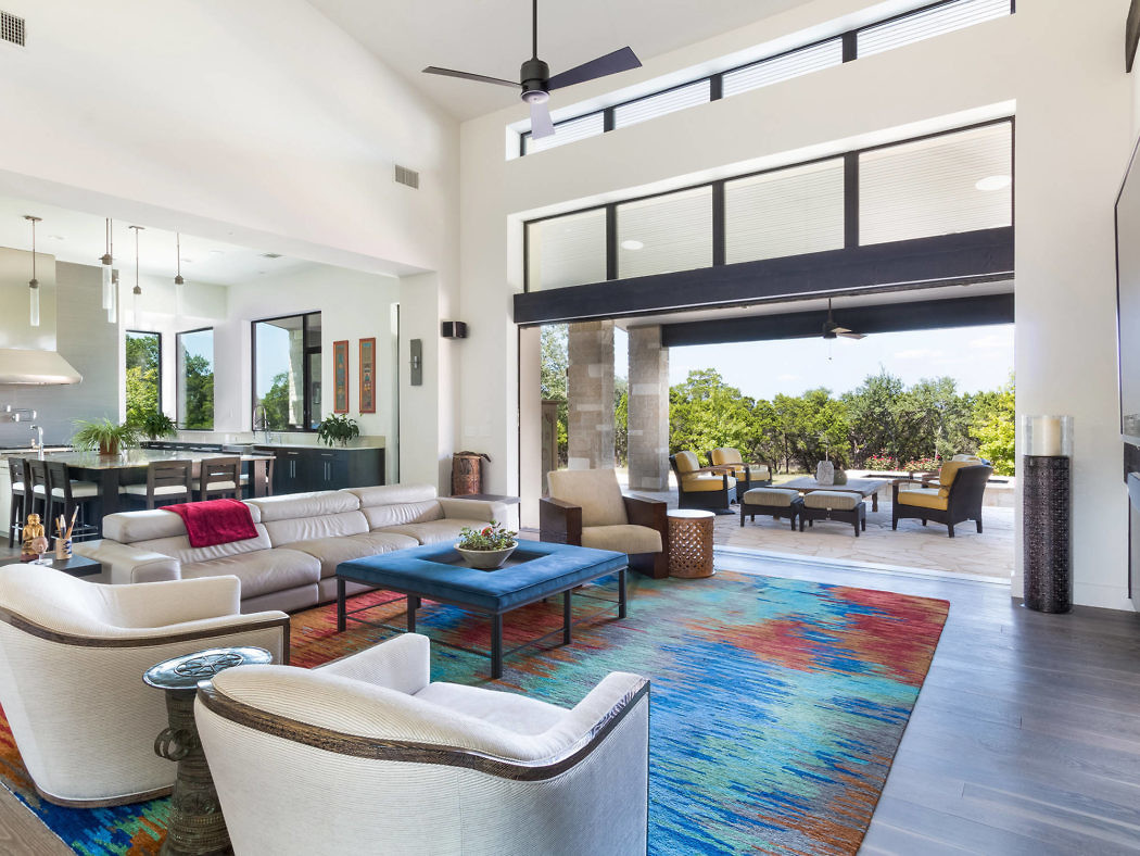Modern living room with open layout leading to outdoor patio.