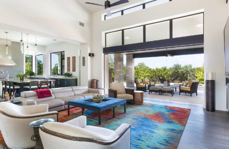 Modern living room with open layout leading to outdoor patio.