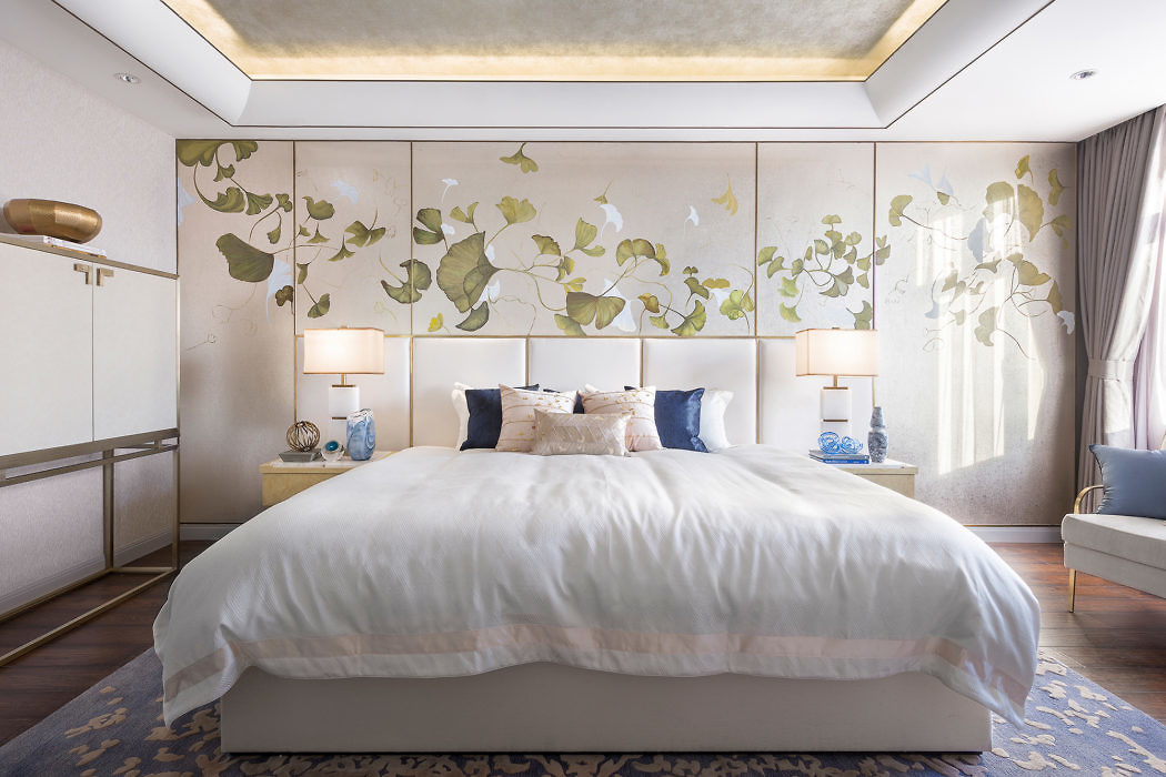 Elegant bedroom with floral wall design, large bed, and soft lighting.