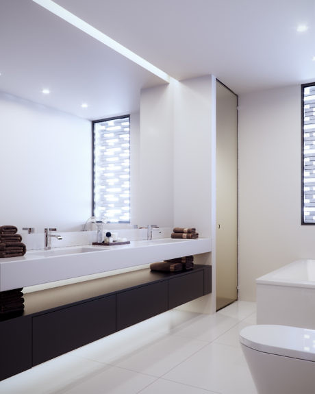 Modern bathroom interior with white fixtures and indirect lighting.