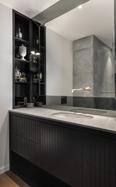 Sleek bathroom with dark cabinetry and concrete accents.