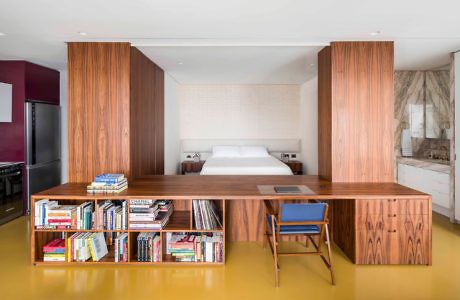 Contemporary bedroom with wooden partitions and built-in bookshelf.