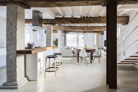 Bright, airy loft with exposed beams and minimalist decor.
