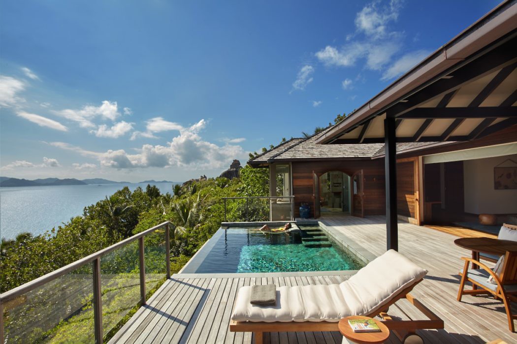 Seaside villa deck with infinity pool overlooking the ocean.