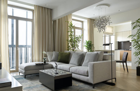 Modern living room with sectional sofa and chandelier.