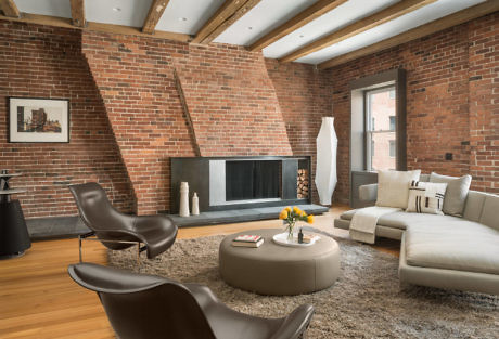 Modern living room with brick walls, fireplace, and contemporary furniture.