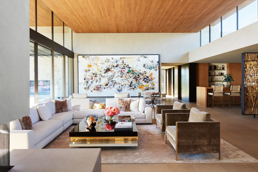 Elegant living room with expansive windows and vibrant artwork.