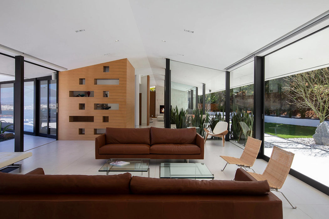 Contemporary living room with sleek furnishings and floor-to-ceiling windows.