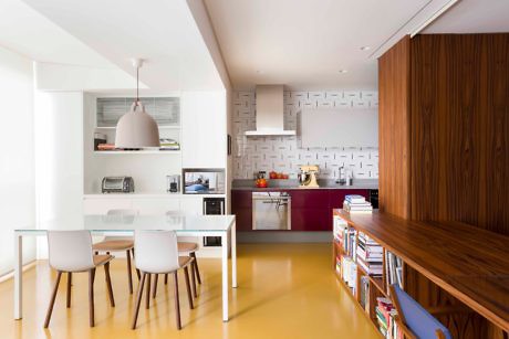 Modern kitchen with white dining set, wood accents, and a purple backsplash.