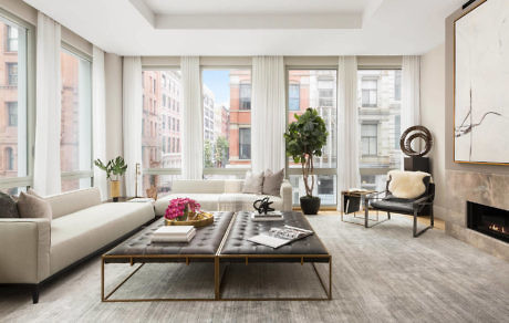 Elegant living room with large windows, minimalist decor, and city view.