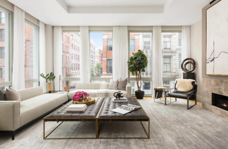 Elegant living room with large windows, minimalist decor, and city view.