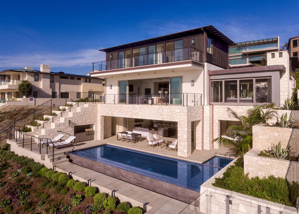 Contemporary home with pool and terrace, ocean view.