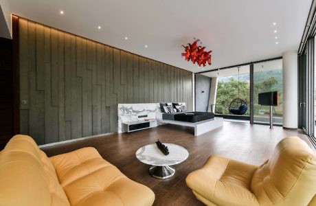 Contemporary living room with sleek lines, mustard sofas, and panoramic view.