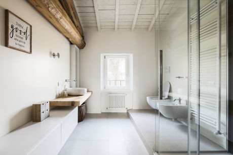 Contemporary bathroom with a glass shower, freestanding tub, and exposed beams