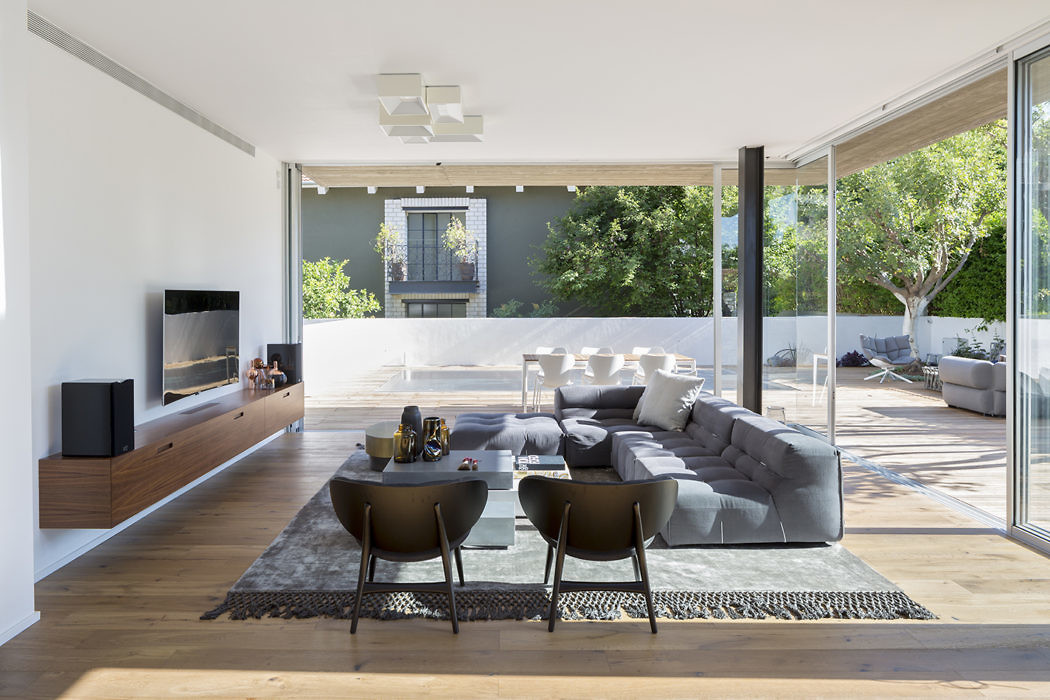 Modern living room with large glass doors opening to patio.