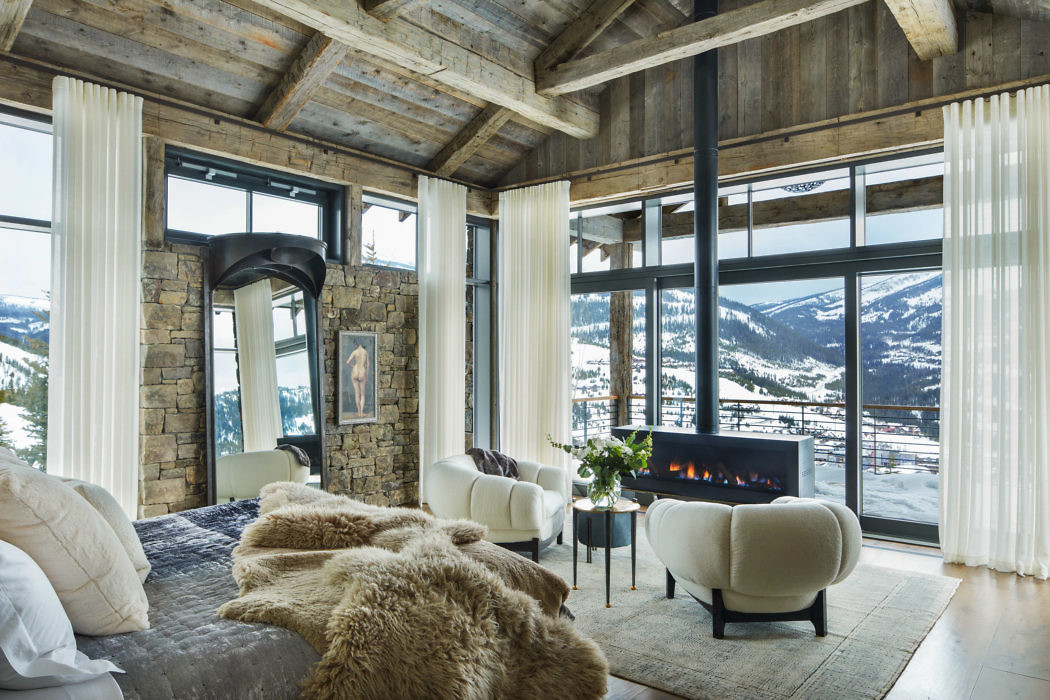 Rustic-chic living room with fireplace and mountain view.