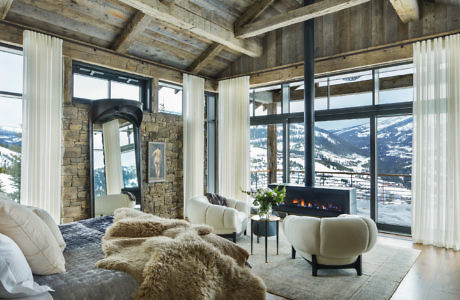 Rustic-chic living room with fireplace and mountain view.