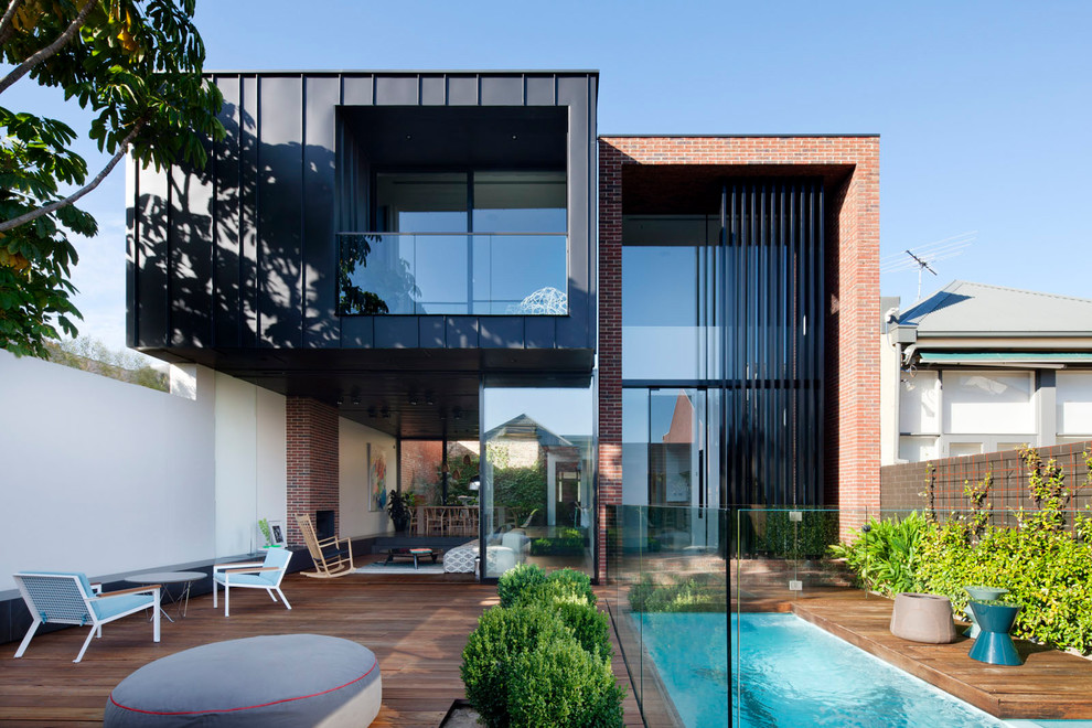 Contemporary house with cantilevered upper level and pool.