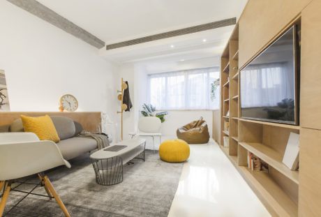 Contemporary living room with wooden shelving and neutral tones.