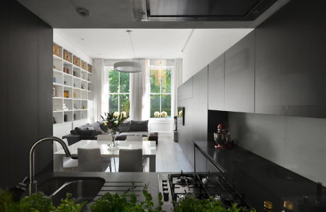 Contemporary kitchen with sleek cabinetry and open-plan living space.