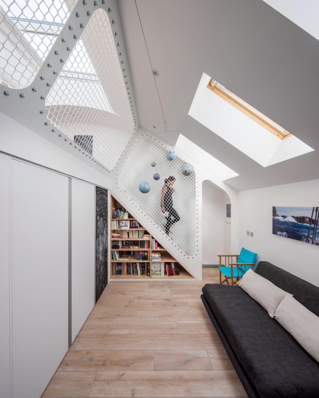 Contemporary attic with climbing wall and skylights.
