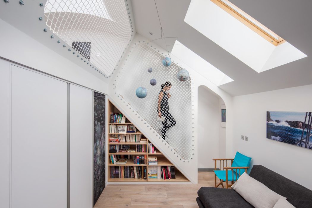 Contemporary attic with climbing wall and skylights.
