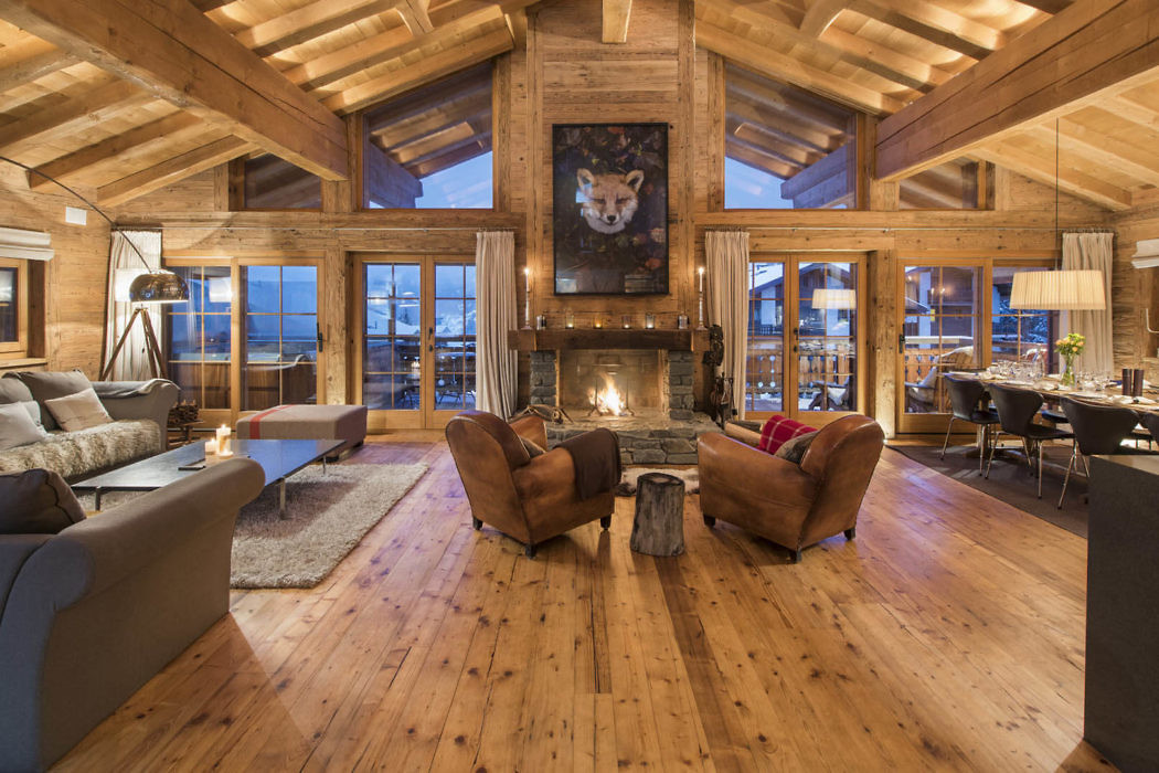 Cozy mountain cabin living room with a fireplace and wood beam ceiling.
