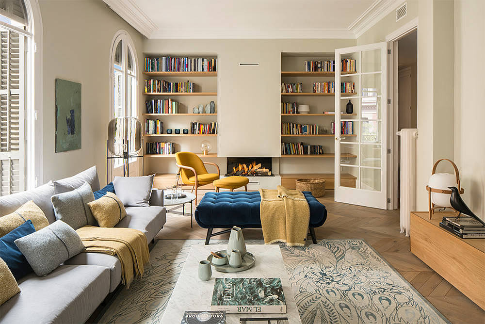 Elegant living space with book-lined walls and colorful furniture.