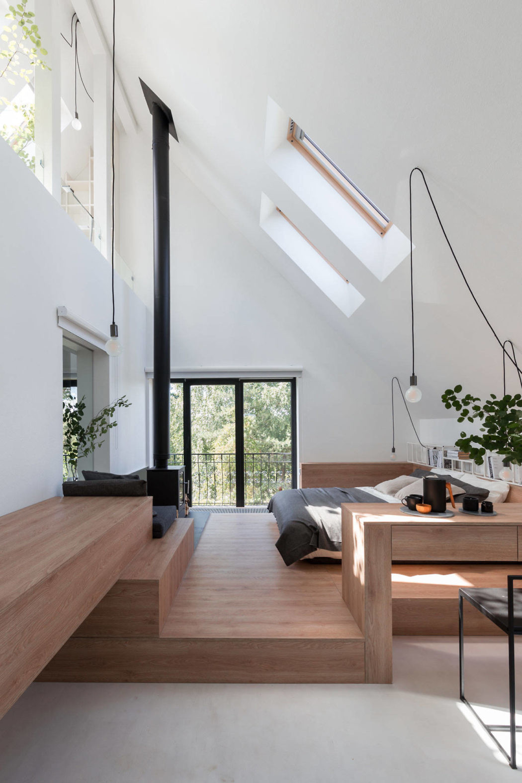 Bright, airy interior with high ceilings, wooden accents, and skylights.