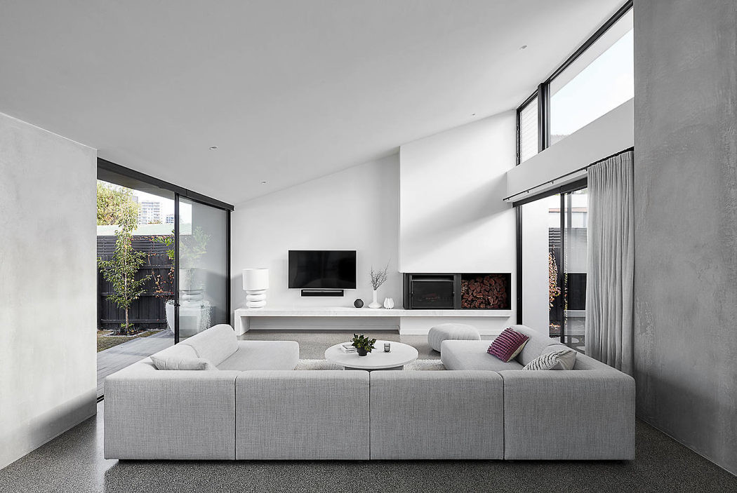 Contemporary living room with large windows and minimalist decor.