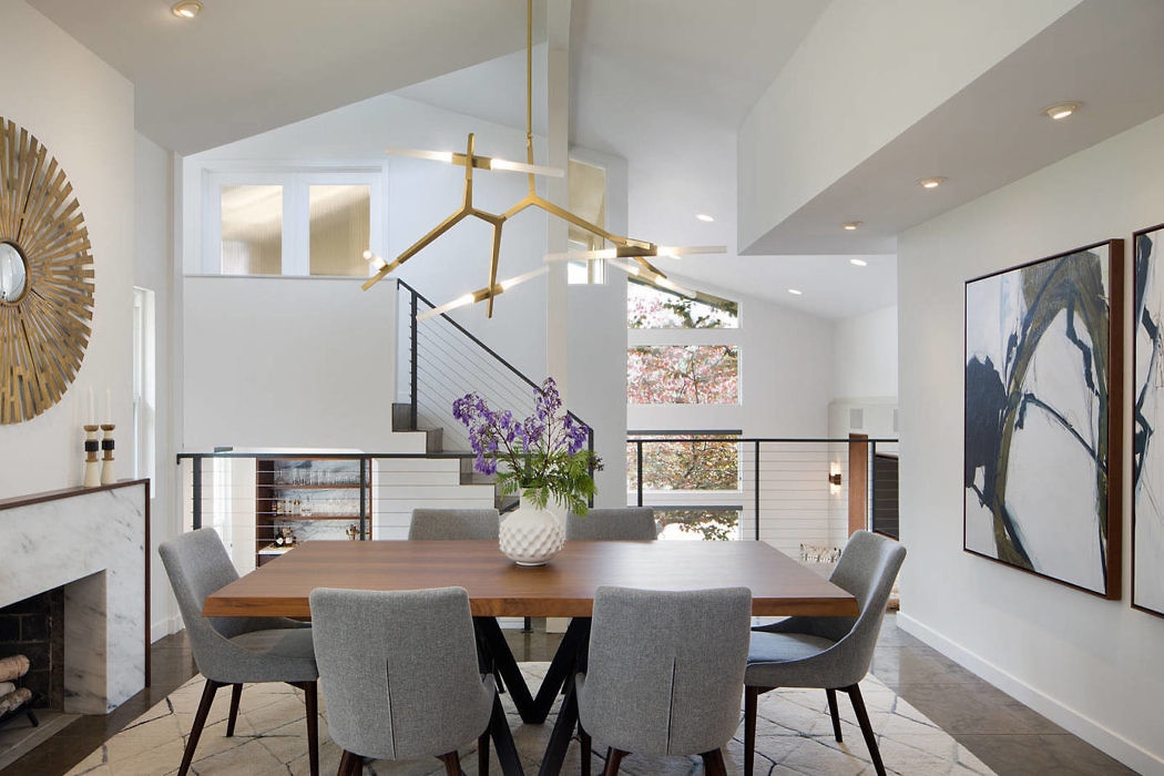 Contemporary dining room with geometric chandelier and art decor.
