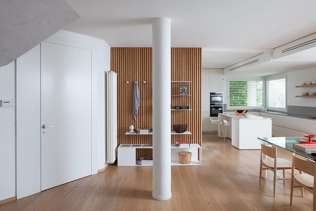 Modern interior with wooden floors, white walls, and a slatted partition.