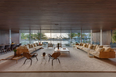 Elegant living space with panoramic windows and wood-paneled ceiling.