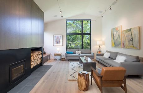 Contemporary living room with large windows and fireplace.