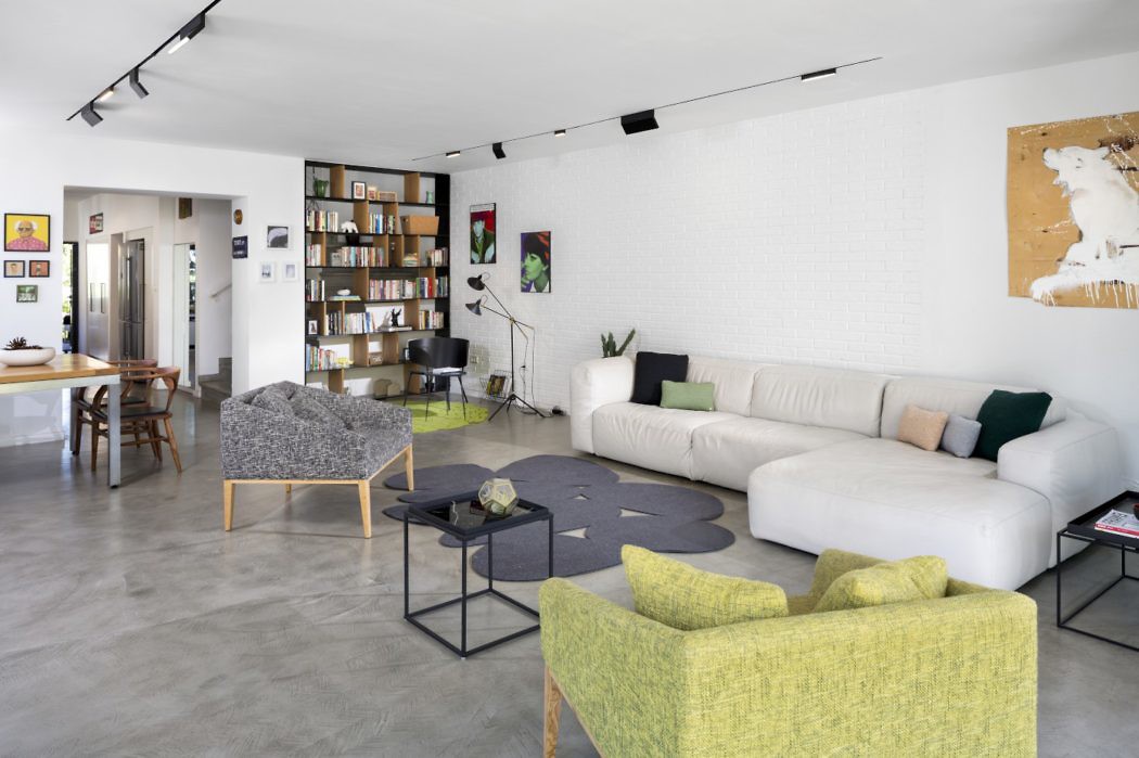 Chic living space with a minimalist design, polished concrete floors, and vibrant accent