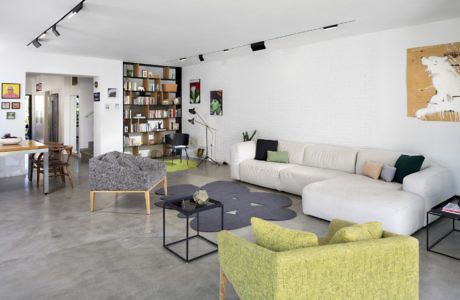 Chic living space with a minimalist design, polished concrete floors, and vibrant accent